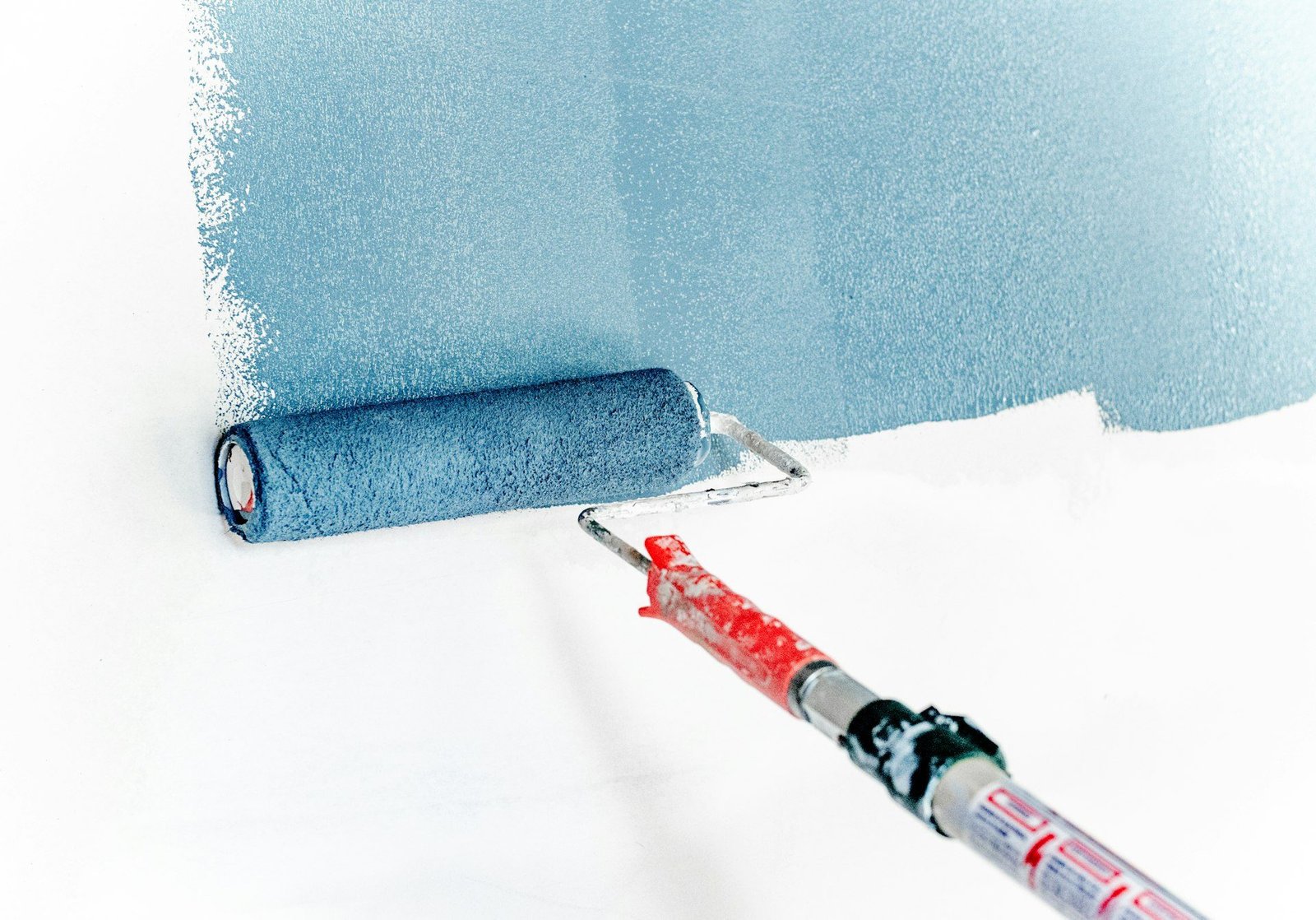 Interior painter applying fresh wall colors in a villa